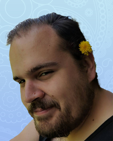 Photo of a young man with a flower in his hair